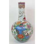 A CHINESE BALUSTER FAMILLE ROSE VASE painted with exotic birds amongst blue rockery,