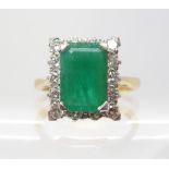 AN 18CT GOLD EMERALD AND DIAMOND RING set with estimated approx 0.50cts of brilliant cut diamonds,