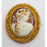 A VICTORIAN CAMEO BROOCH DEPICTING A CHERUB in a bright yellow metal mount embellished with