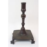 A 17TH CENTURY BRONZE CANDLESTICK possibly Dutch, upon square plinth with four paw feet, the stick