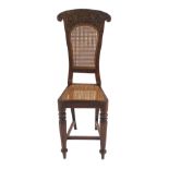 AN ANGLO INDIAN ROSEWOOD HIGH CHAIR the back rest carved with scrolling foliage surrounding a cane