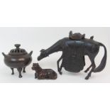 A CHINESE BRONZE INCENSE BURNER cast as a horse with decorative saddle, 16.5cm high, recumbent horse