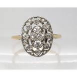 AN 18CT GOLD VINTAGE DIAMOND CLUSTER RING of fine pierced design set with old cut and eight cut