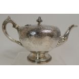 A VICTORIAN SILVER TEAPOT by James McKay, Edinburgh 1857, of globular shape with scrolling handle,