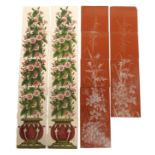 A TERRACOTTA FIVE TILE FIRE INSERT PANEL painted in white enamel with dog roses, thistles and