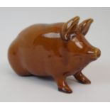 A SCOTTISH POTTERY PIG with treacle and green glaze, 17cm long Condition Report: Available upon