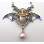 A GERMAN GOTHIC JUGENDSTIL PLIQUE-A-JOUR ENAMELLED WINGED PENDANT with grotesque mask, set with
