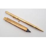 A 14K GOLD LADIES PROPELLING PENCIL WITH AND A 9CT GOLD PENCIL SLEEVE the ladies pencil has linear