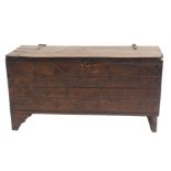 AN OAK COFFER the hinged two plank top set with wrought iron hinged above a geometric and foliate