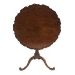 A MAHOGANY TILT-TOP TRIPOD TABLE the pie crust top above a fluted column and on scroll legs, 72cm