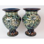 A PAIR OF VICTORIAN DOULTON LAMBETH FAIENCE VASES painted with passion flowers by Helen A Arding,