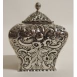 A SILVER TEA CADDY by William Comyns & Sons, London 1887, of square tapering form with flowerhead