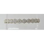 A 9CT GOLD DIAMOND FLOWER BRACELET ten flower clusters set with estimated approx 1.30cts of