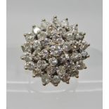 A BRIGHT YELLOW METAL DIAMOND CLUSTER RING in classic basket mount, set with estimated approx 1.