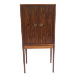 A HENNING KORCH DANISH ROSEWOOD TWO DOOR CABINET ON STAND with two small internal drawers and fitted
