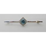AN 18CT WHITE GOLD DIAMOND AND BLUE ZIRCON BROOCH diamond content approx 0.50cts, dimensions 5.8cm x