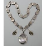 A VICTORIAN WHITE METAL LOCKET AND CHAIN the chain engraved to every link with birds and butterflies