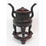 A CHINESE BRONZE TWO-HANDLED CENSER the pierced out-swept handles joined to a diaper band and on