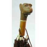 AN EARLY 20TH CENTURY PARASOL the handle carved with an articulated monkey head with a push-button