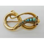 A YELLOW METAL SNAKE BROOCH SET WITH TURQUOISE AND GARNETS with engraved detail to the body, 3.9cm x