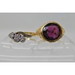 TWO VINTAGE RINGS an 18ct gold scroll mount ring set with a garnet, of approx 10mm, finger size