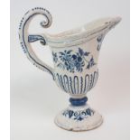 AN 18TH CENTURY FRENCH TIN GLAZED JUG with blue and white floral decoration and scrolling handle,