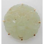 A CHINESE GREEN HARDSTONE BROOCH CARVED WITH TWO MOTHS in a bright yellow metal mount, diameter