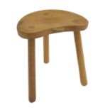 A ROBERT "MOUSEMAN" THOMPSON THREE LEGGED OAK STOOL with kidney shaped top with octagonal legs, with