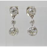 A PAIR OF DIAMOND DROP EARRINGS set in millgrained white metal settings, drop approx 1.7cm,