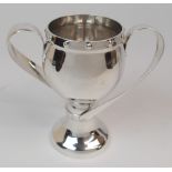 AN ARTS AND CRAFTS SILVER TWIN HANDLED VASE by Samuel Jacob, London 1910, of baluster shape with