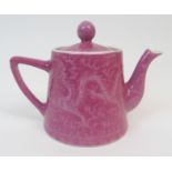 A CHINESE PORCELAIN TEAPOT AND COVER incised on a pink ground with two dragons chasing The Flaming