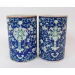 A PAIR OF CANTON BRUSH WASHER VASES painted with bats, peonies and brocade on a blue ground, gilt