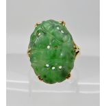 A BRIGHT YELLOW METAL CHINESE GREEN HARDSTONE RING carved with fruit. Dimensions of the hardstone