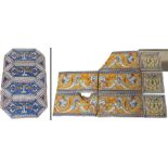 A GROUP OF FOUR LOZENGE SHAPED ITALIAN FAIENCE TILES each decorated with a winged figure, dolphins