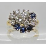 AN 18CT GOLD DIAMOND AND SAPPHIRE RETRO CLUSTER RING largest diamond is estimated approx 0.25cts
