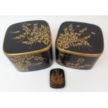 TWO BLACK AND GOLD LACQUERED TWO-SECTION BOXES decorated with birds amongst foliage (cracks and