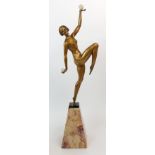 AN ART DECO FIGURE OF A WOMAN modelled naked and dancing with spheres, upon spreading marble base,