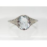 A 10K WHITE GOLD ART DECO STYLE AQUAMARINE RING with pierced setting and shoulders, aquamarine