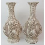 A PAIR OF WHITE PAINTED CINNABAR LACQUERED HEXAGONAL LOBED VASES carved with flowers on a diaper