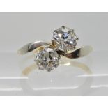 AN 18CT GOLD AND PLATINUM TWIN OLD CUT DIAMOND RING in the classic crown on a twist setting, the