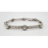 A PLATINUM AND DIAMOND ART DECO STYLE BRACELET the larger diamonds are estimated approx at 0.30cts