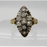 A bright yellow metal old and rose cut diamond marquis cluster ring, (one diamond lacking) estimated