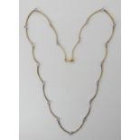 A 9ct gold scallop shaped necklace set with diamonds to an estimated approx total of 0.66cts, length