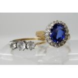 A 9ct gold blue gem and clear gem cluster ring, size M and a 9ct and silver three stone clear gem