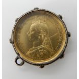 An 1887 half sovereign enamelled in colours on one side in white metal glazed mount, weight 5.8gms
