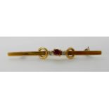 An 18ct gold ruby and diamond brooch, 4.8cm, weight approx 3.2gms Condition Report: Available upon