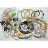 A bag full of vintage costume jewellery to include a bracelet by Kabin of New York and buttons etc