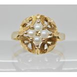 A bright yellow metal continental hallmarked ring set with pearls head size 12.5mm, finger size N,