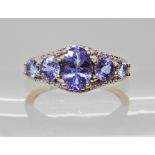 A 9ct gold tanzanite five stone ring with diamond accent, finger size L, weight 2.4gms Condition