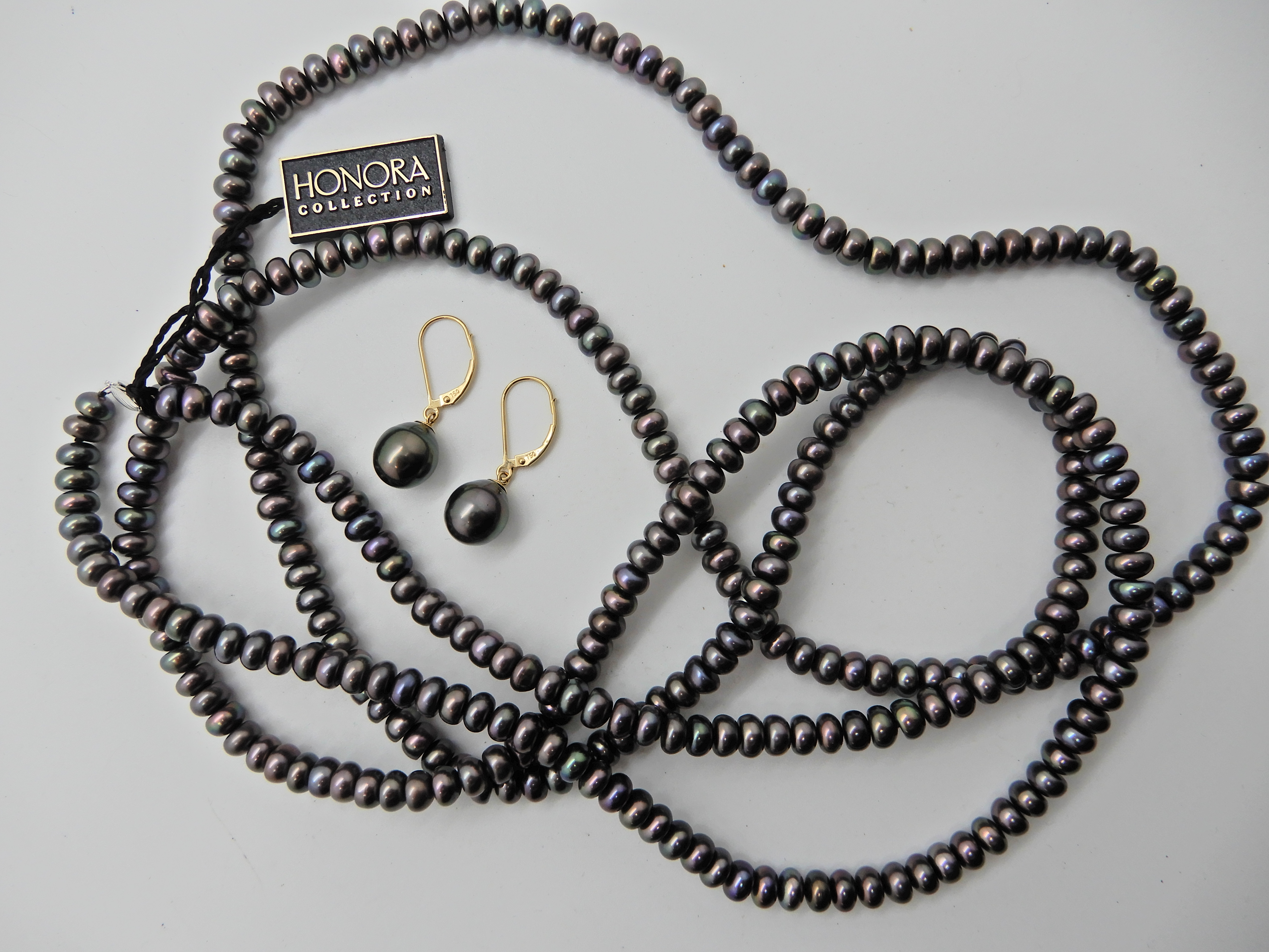 A long string of Honora black pearls with 14k gold clasp and 18ct gold mounted black pearl